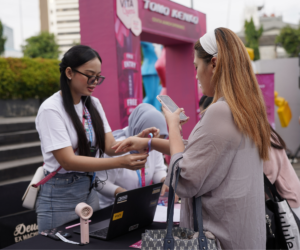 Pemasangan wristband pengunjung di meja registrasi event Tomo Kenko